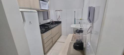a small kitchen with a sink and a stove at STRELART RESIDENCE in Brasilia