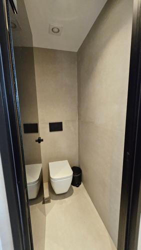 a small bathroom with a toilet and a sink at Kooba Villas in Gázion