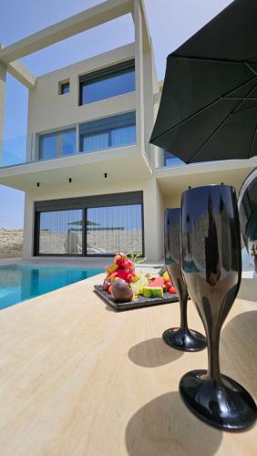 a chair sitting on a table in front of a house at Kooba Villas in Gázion
