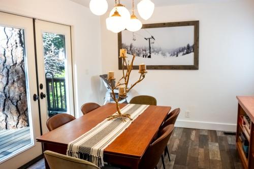 a dining room with a wooden table and chairs at The Mighty Pines Retreat + Large Patio + BBQ+View! in Lake Arrowhead