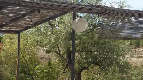 a white lantern hanging under a wooden roof at Al Jatib in Baza