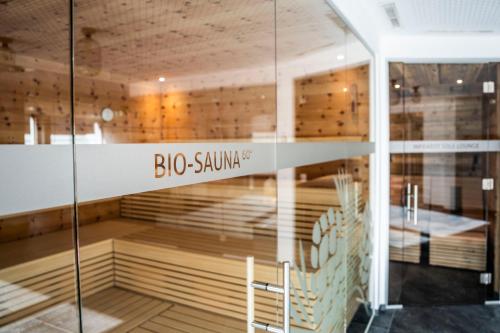 a store window with a sign that reads bio sumuna at Hotel Helvetia in Müstair