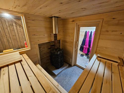 an inside view of a wooden cabin with two benches at Cottage Golenovo in Podvelka