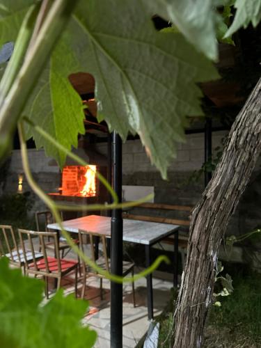 a table and chairs with a fire in a garden at Villa For Rent in Durrës
