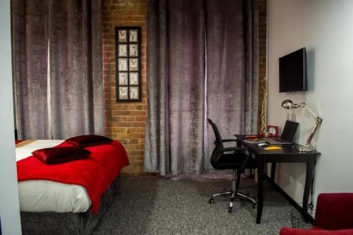 1 dormitorio con 1 cama y escritorio con ordenador en Kick back relax stylish space en Nottingham