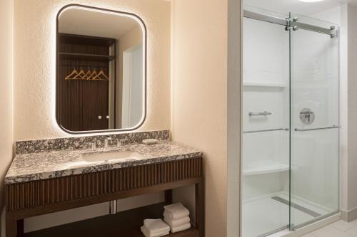 a bathroom with a sink and a shower at Burton House, Beverly Hills, A Tribute Portfolio Hotel in Los Angeles
