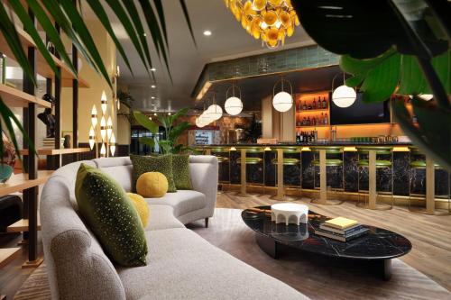 a living room with a couch and a table at Burton House, Beverly Hills, A Tribute Portfolio Hotel in Los Angeles
