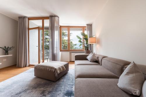 a living room with a couch and a large window at Promenaden Lounge in Merano