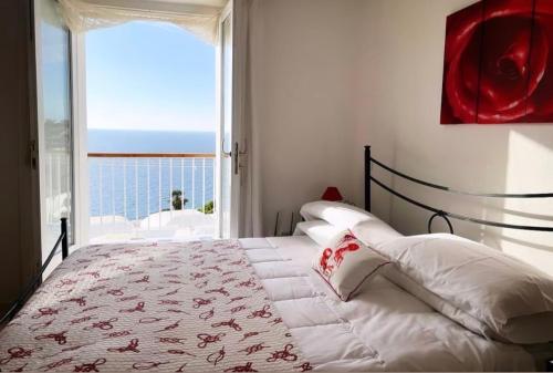 a bedroom with a bed with a view of the ocean at Ponza Le Forna in Ponza