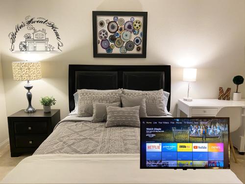 a bedroom with a bed with a laptop on it at Bella's sweet house 11155 in Mira Loma