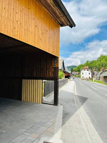 a building with a letter p on the side of a road at Slovenian House Vida in Bled