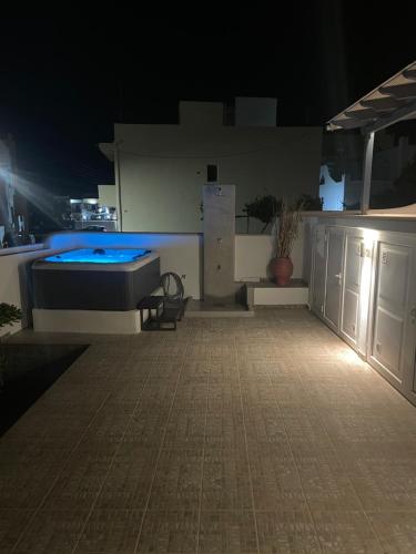 a room with a bed and a pool at night at Villa Maria Naxos -with new hot tub in Naxos Chora