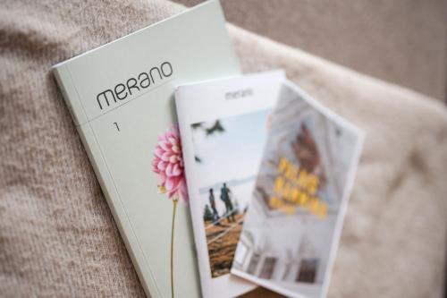 two books sitting next to each other on a table at Promenaden Lounge in Merano