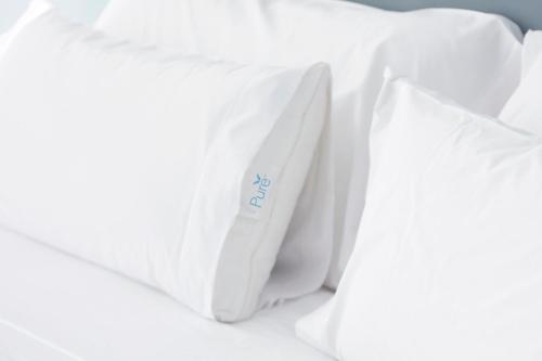 a pile of white pillows on a bed at Residence Inn by Marriott Dallas Plano/Legacy in Plano