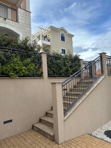 a building with stairs in front of a house at LUSTICA BAY GARDEN STUDIO, Centrale in Tivat
