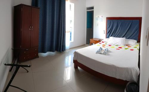 Postel nebo postele na pokoji v ubytování Hotel Bella Orquidea