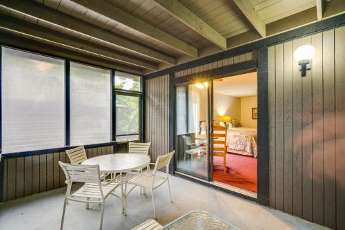 a dining room with a table and chairs and a bedroom at 1 Mi to Margaritaville Resort Cottage with Fire Pit in Osage Beach