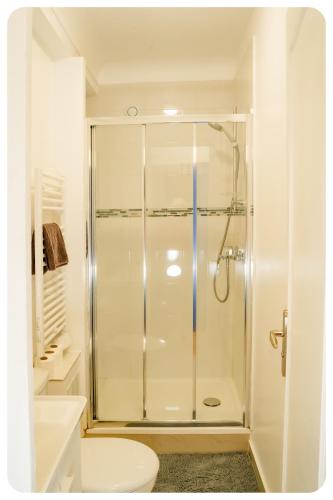 une salle de bain blanche avec douche et toilettes dans l'établissement Qhome 4 - F2 entre Paris et Disney - Parking privé, à Villiers-sur-Marne