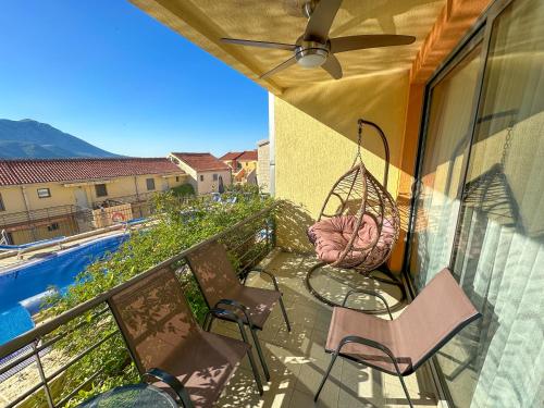 a balcony with chairs and a hammock and a swing at The Sun & Sea Apartment in Becici