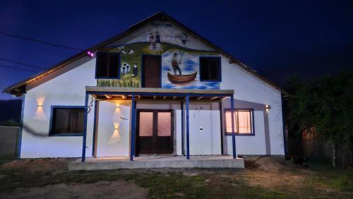 a house with a painting on the side of it at Casa de la Dunăre-Dăeni in Dăeni