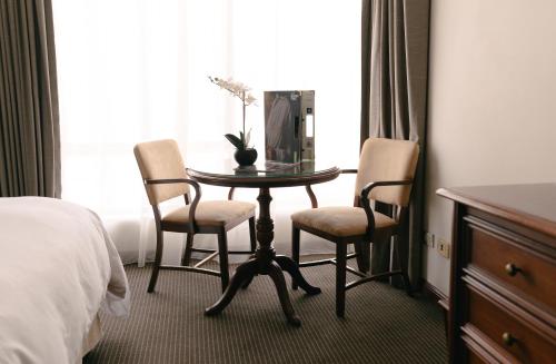 Postel nebo postele na pokoji v ubytování LUOXO Hotel