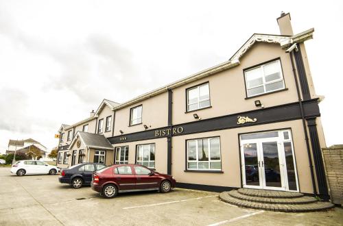 a red car parked in front of a building at The Frontier Hotel in Bridgend