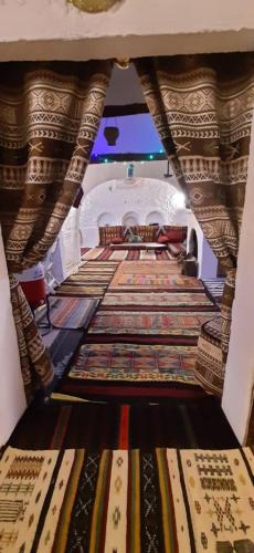 a large room with many carpets on the floor at Thanmirth Ghardaia in El Ateuf