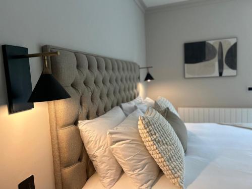 a bed with two pillows and a lamp on it at The Glen Quarter in Kinsale