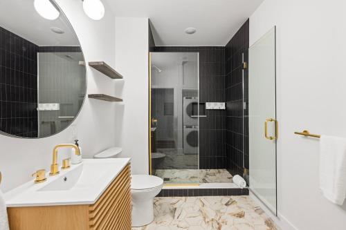 a bathroom with a shower and a toilet and a sink at Sosuite at The Loxley - Old City in Philadelphia