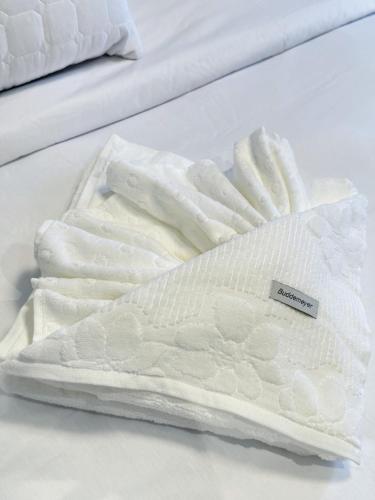 two white towels on a bed in a room at São Paulo Nações Unidas - Luxury Suíte in São Paulo