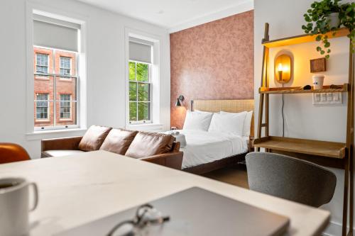 a hotel room with a bed and a couch at Sosuite at The Loxley - Old City in Philadelphia