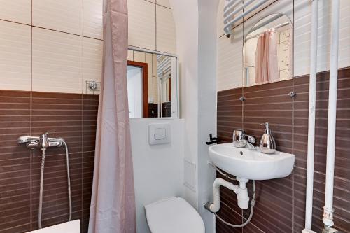 a bathroom with a sink and a toilet and a shower at Wave Apartments - Aurora in Gdynia