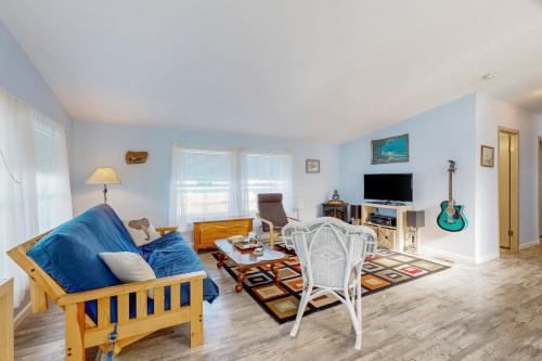 a living room with a blue couch and a table at Blue Heaven Beach House in Rockaway Beach