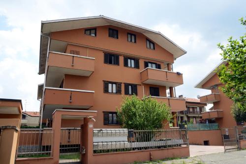 an apartment building with a fence in front of it at [Fiori del Lario] Excl. 110MQ Fiera/Milano/MXP in Cesate