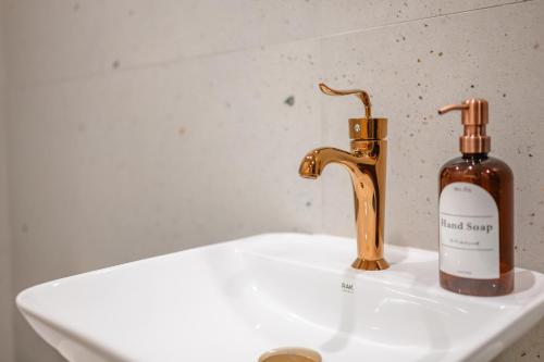 a bottle of hand soap next to a bathroom sink at Capital Hideaway in Valletta