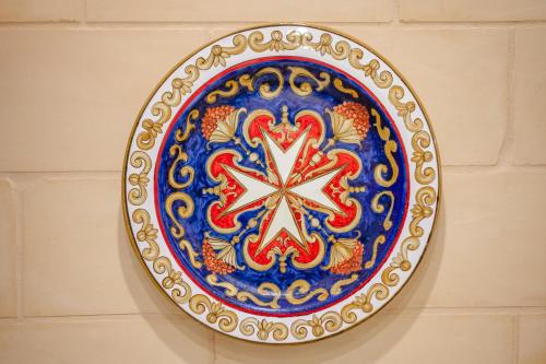 a plate is hanging on a wall at Capital Hideaway in Valletta