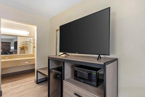 a flat screen tv on a stand in a room at Best Western Inn of Brenham in Brenham