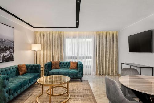 a living room with a couch and a table at Radisson Residences Cairo Heliopolis in Cairo