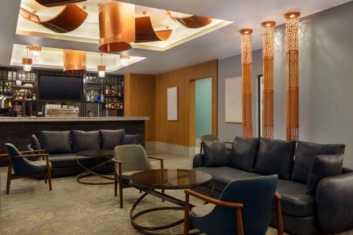 a lobby with couches and chairs and a bar at Radisson Residences Cairo Heliopolis in Cairo