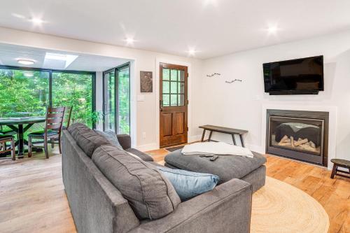 a living room with a couch and a fireplace at Sawyer Retreat with Fire Pit Less Than 2 Mi to Beaches! in Sawyer
