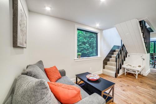 a living room with a couch and a table at Sawyer Retreat with Fire Pit Less Than 2 Mi to Beaches! in Sawyer