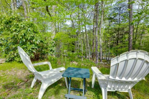 two white chairs and a table in the grass at Killingly Barnyard Studio in Wine Country! in Pineville