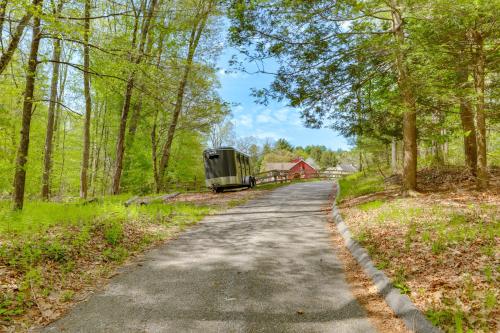 a road in the woods with a trailer on the side at Killingly Barnyard Studio in Wine Country! in Pineville