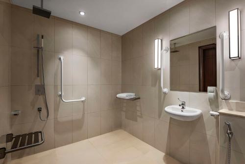 a bathroom with a shower and a sink at Radisson Hotel Muscat Panorama in Muscat