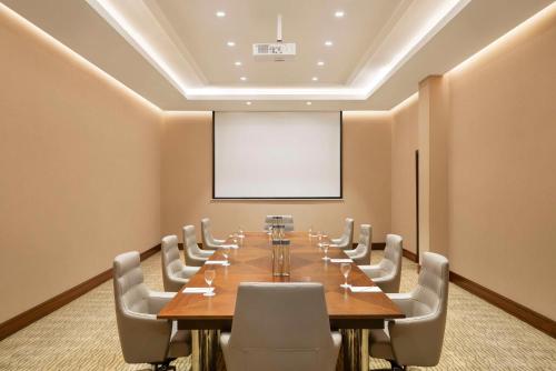 a large conference room with a long table and chairs at Radisson Hotel Muscat Panorama in Muscat
