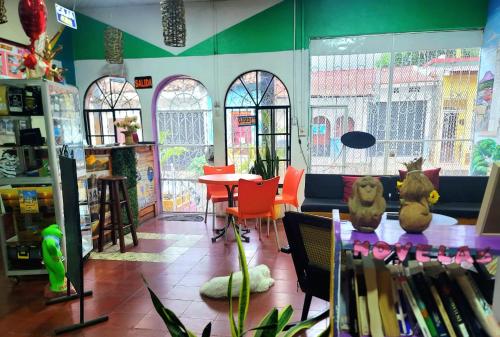 a book store with a table and chairs and windows at Hostal Leyendas in León