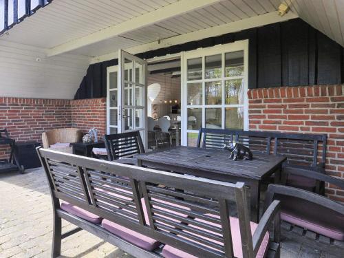 a wooden table with a cat sitting on top of it at 6 person holiday home in Jerup-By Traum in Jerup
