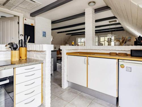 a kitchen with white cabinets and a counter top at 6 person holiday home in Jerup-By Traum in Jerup
