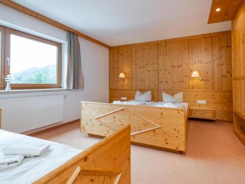 a room with two beds and a window at Mooshäusl Large in Hopfgarten im Brixental