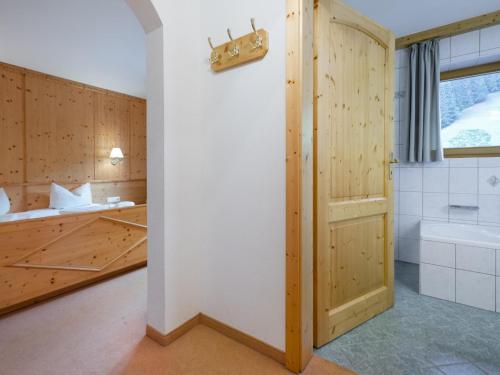 a bathroom with a tub and a sink and a toilet at Mooshäusl in Hopfgarten im Brixental